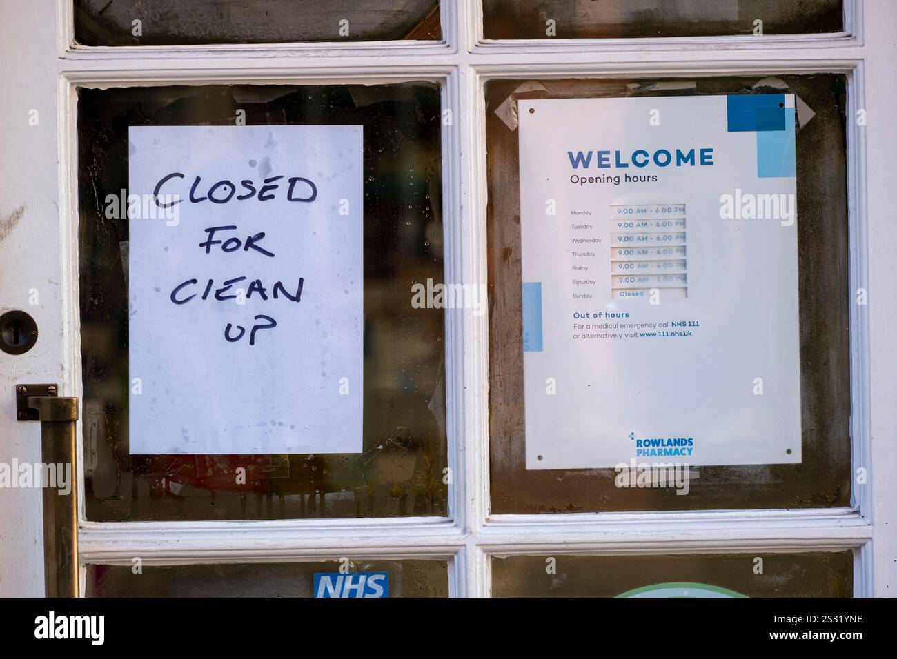 Closed for clean up sign as people in the Worcestershire town of Tenbury Wells clean up silt and mud following flooding during Storm Bert on 25th November 2024 in Tenbury Wells, United Kingdom. As heavy rainfall from Storm Bert impacted right across the UK, the town of Tenbury Wells flooded after river levels at Kyre Brook rose, causing a wall to collapse on Market Street allowing flood waters to fill the town, inundating properties. Further damage was caused by a tractor being driven through the flooded streets causing a wave which broke windows in local businesses. Stock Photo