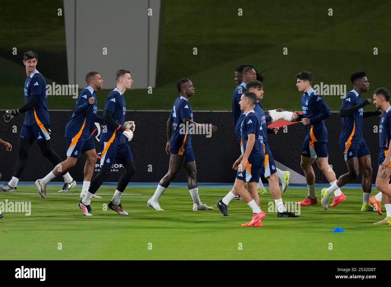 Real Madrid players warm up during a practice session on the eve of