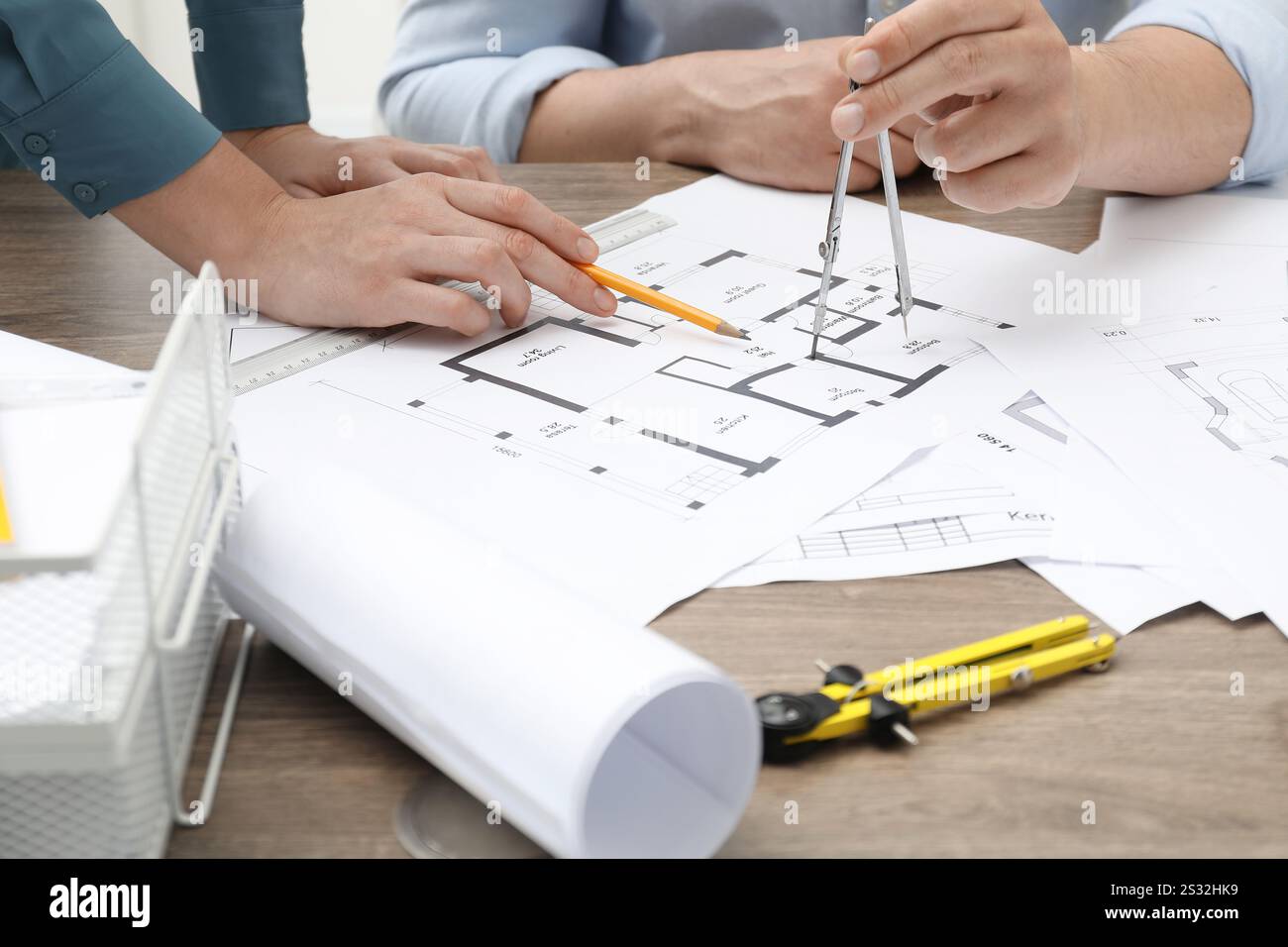 Architects working with project, closeup. Different technical drawings on wooden table Stock Photo