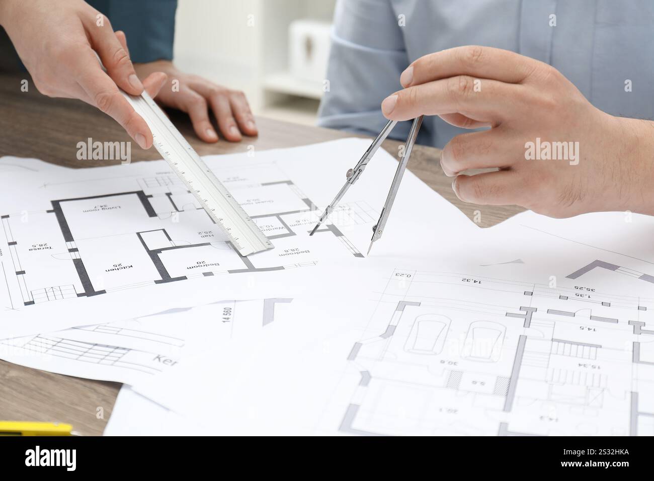 Architects working with project, closeup. Different technical drawings on wooden table Stock Photo