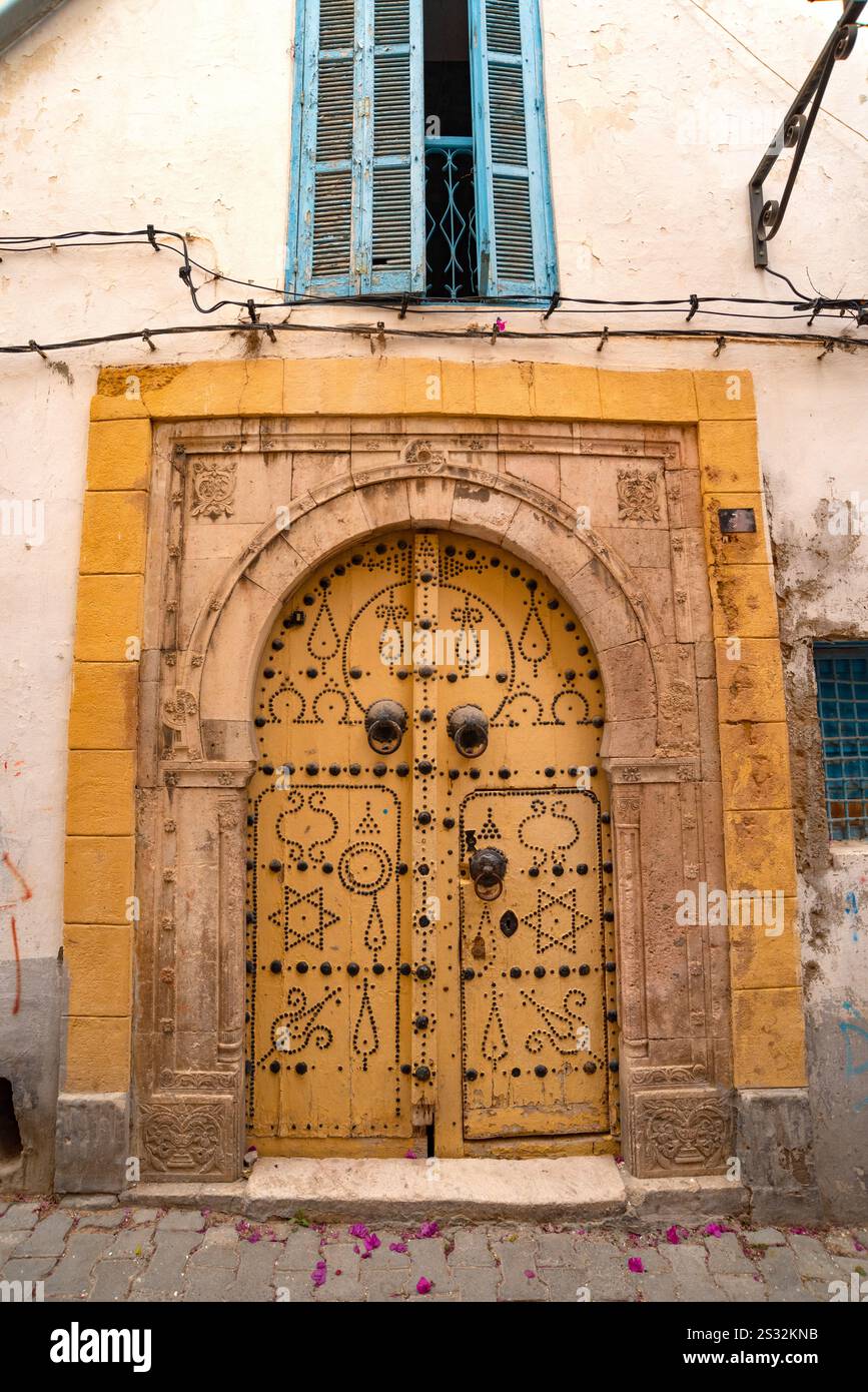 Detailed yellow ornate design of a typical door in the Medina of Tunis, a UNESCO designated quarter of the Tunisian capital, Tunisia Stock Photo