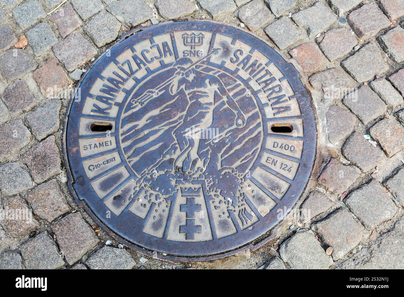 Manhole cover with an image of Neptune Fountain, Old City, Gdansk, Poland Stock Photo