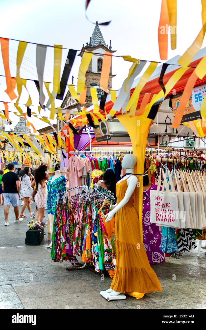 Colourful craft market with dresses and flags at Pelourinho, Salvador. A vibrant celebration of Brazilian culture and fashion. Stock Photo