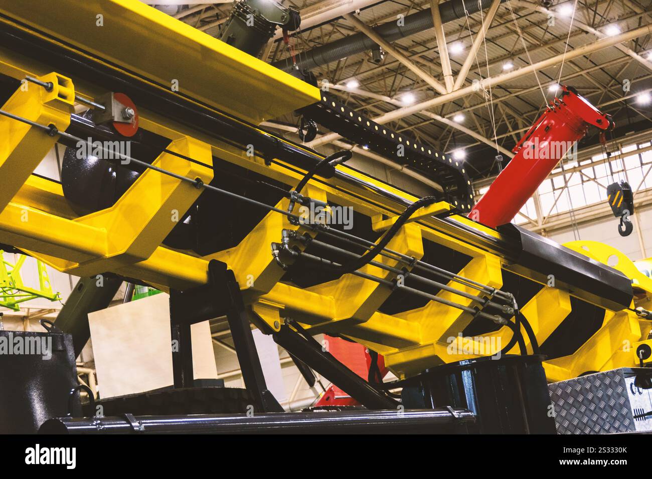 A drilling rig mounted on a truck, featuring a yellow boom and drilling ...
