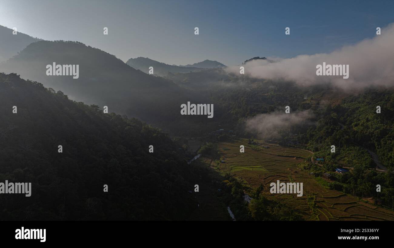 An aerial view of terraced rice fields in a charming valley of golden ...