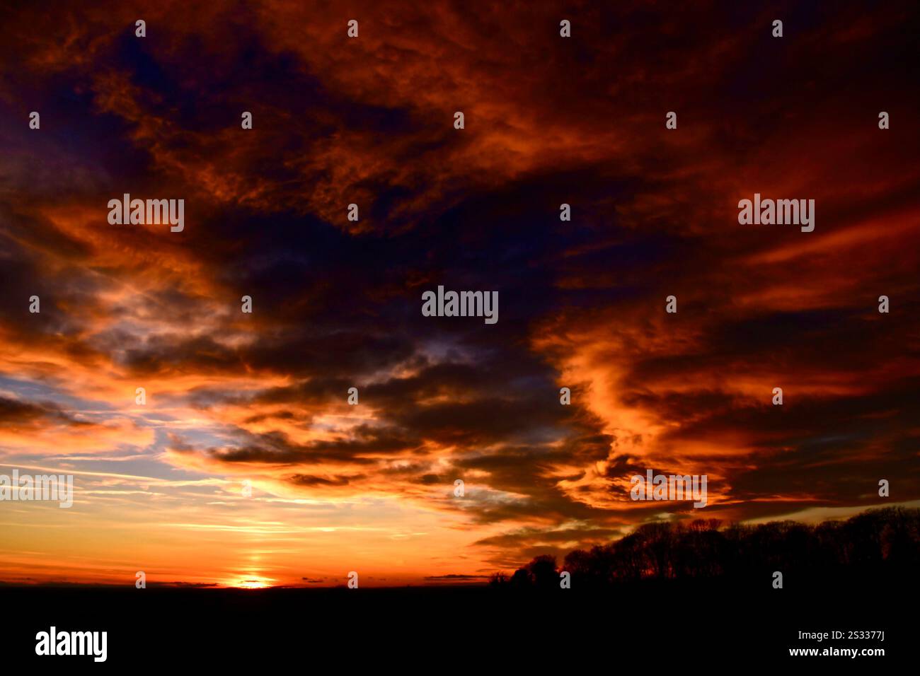 Dramatic clouds and sunset over a Lincolnshire field. Stock Photo