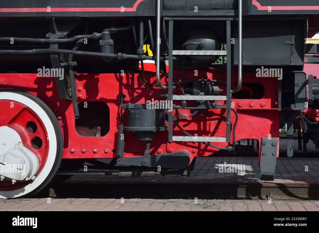 Wheels of the old black steam locomotive of Soviet times. The side of ...