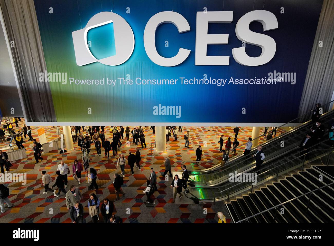 People attend the CES tech show Wednesday, Jan. 8, 2025, in Las Vegas ...