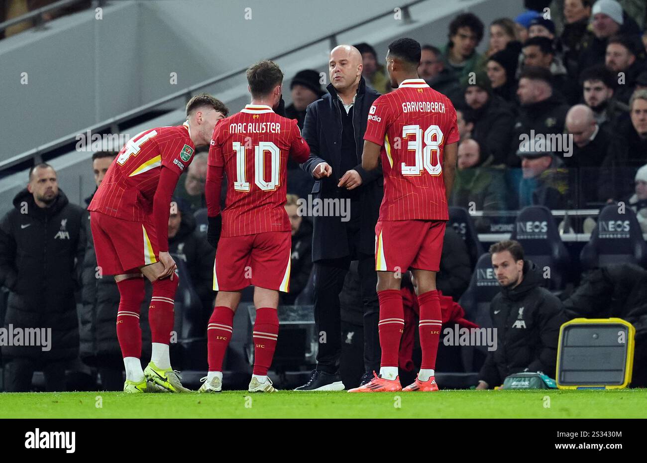 Liverpool manager Arne Slot gives instructions to Conor Bradley, Alexis