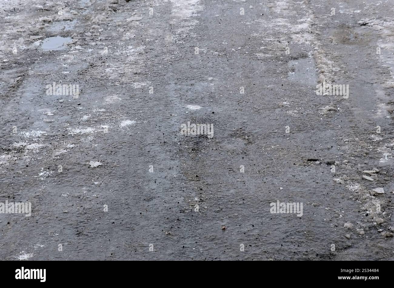 Freezing Roard Condition Damaged asphalt road with potholes caused by freezing and thawing ...