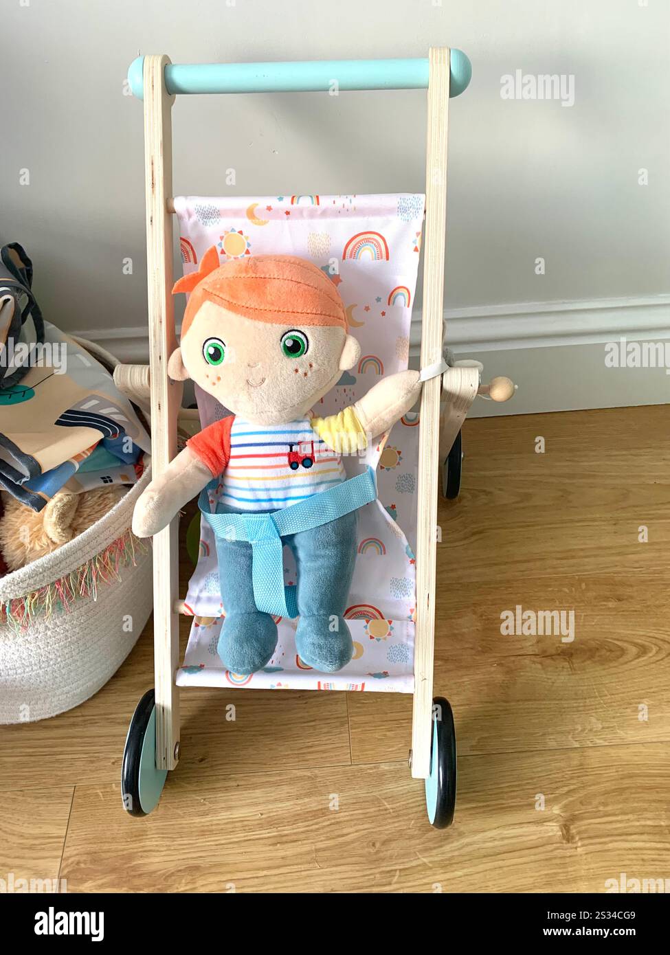 Childs doll and push chair play thing toy books reading cupboard inside toy baby play thing things trolley wheels push pram toy toys games drawing UK - Smartphone Captured Stock Image