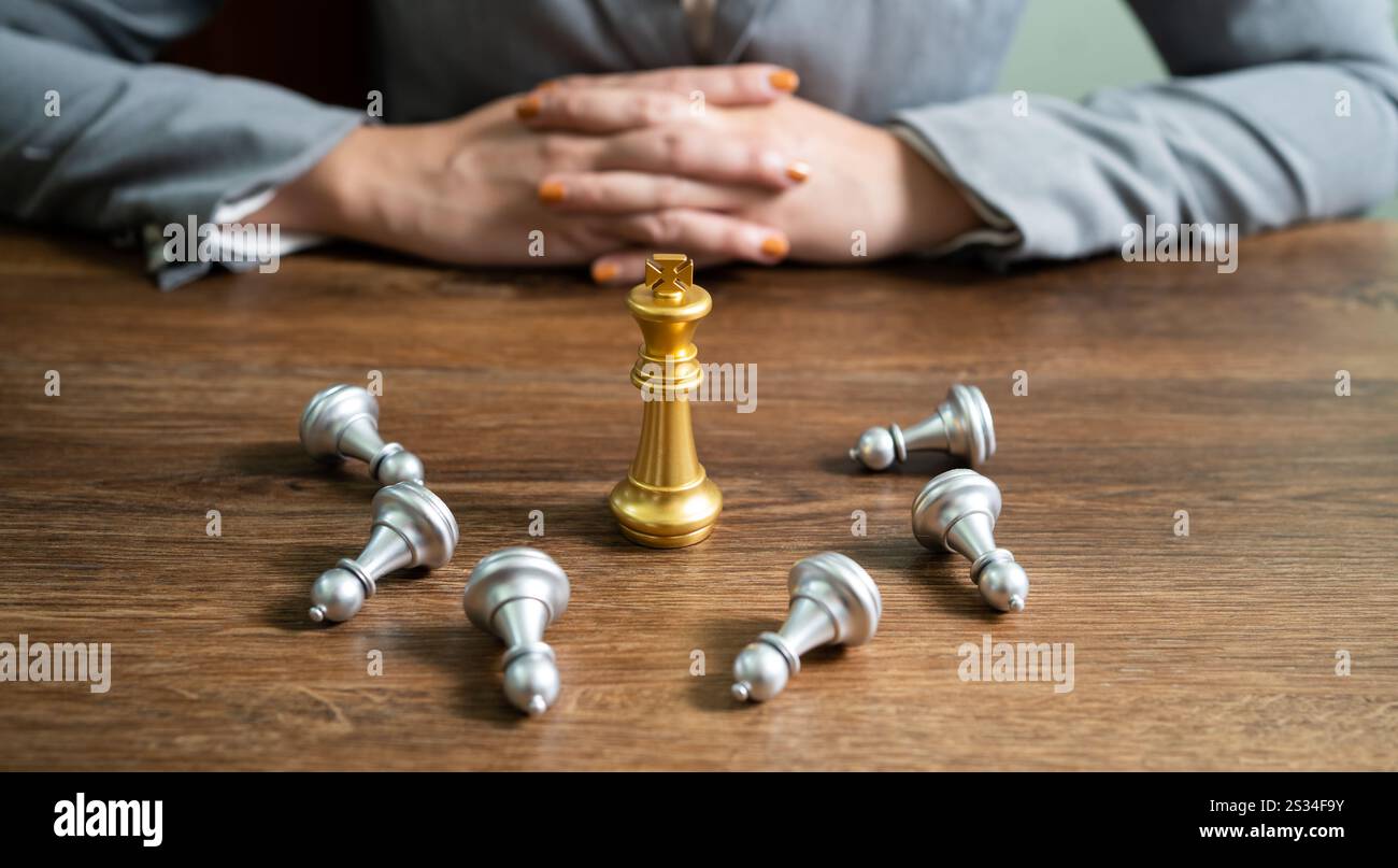 Chess leadership  victory concept with gold winner stand alone with fallen silver chess pieces King wins the game Decision and achievement goal concep Stock Photo