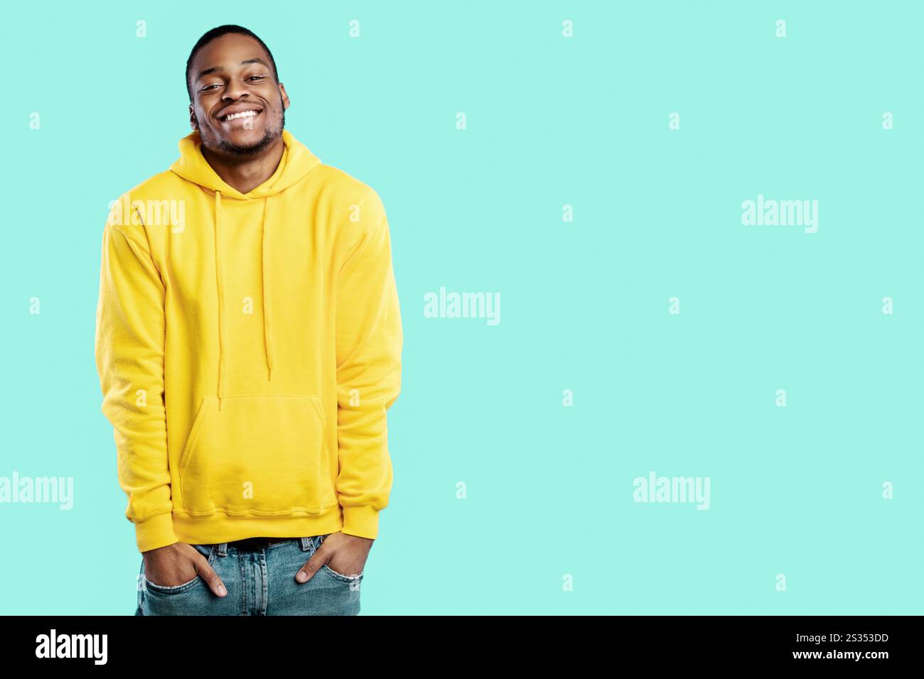 Happy African Guy Posing With Hands In Pockets, Blue Background Stock Photo