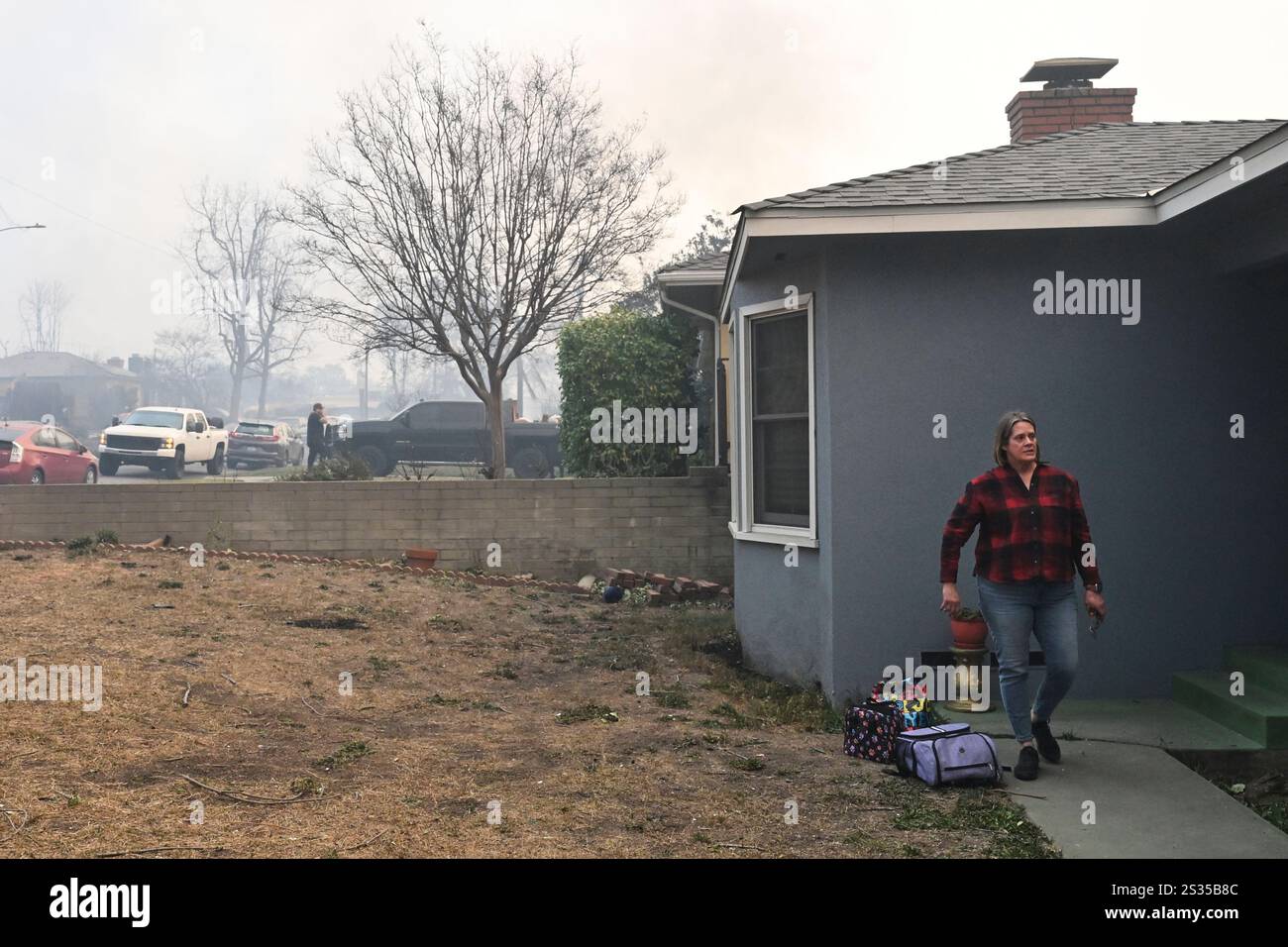Lisa Diaz evacuates her home because of the Eaton Fire, Wednesday, Jan