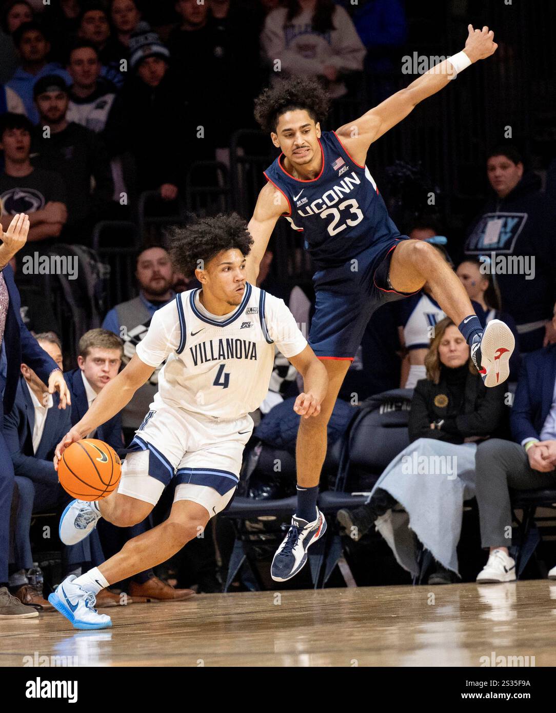 Tyler Perkins Connecticut forward Jayden Ross (23) leaps over Villanova guard Tyler ...