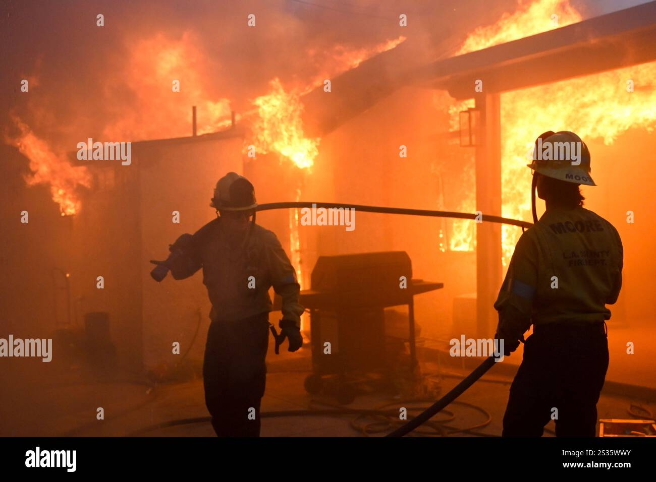Firefighters battle the Eaton Fire as it engulfs structures Wednesday