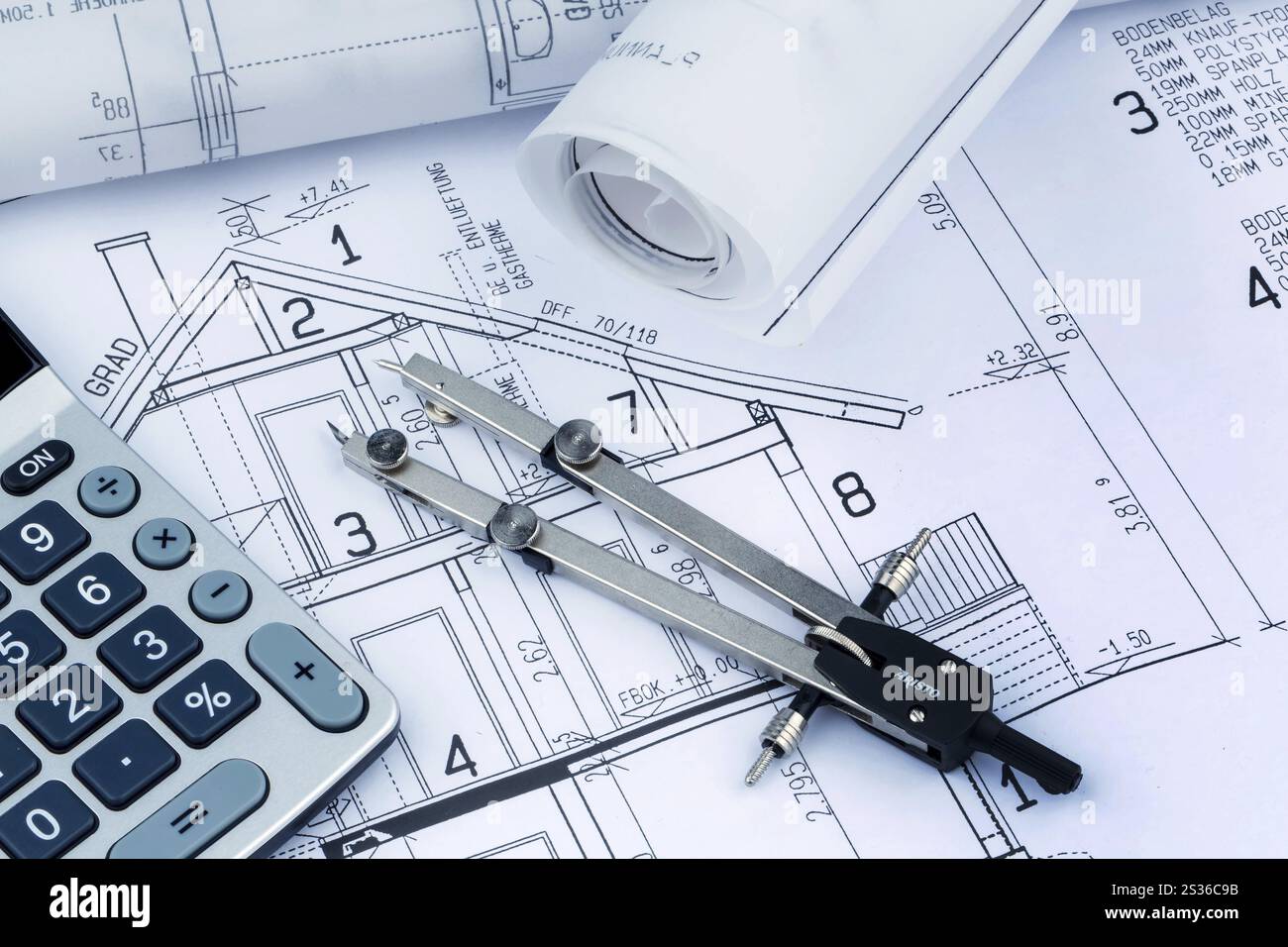 An architect's construction plan with a calculator. Symbolic photo for ...