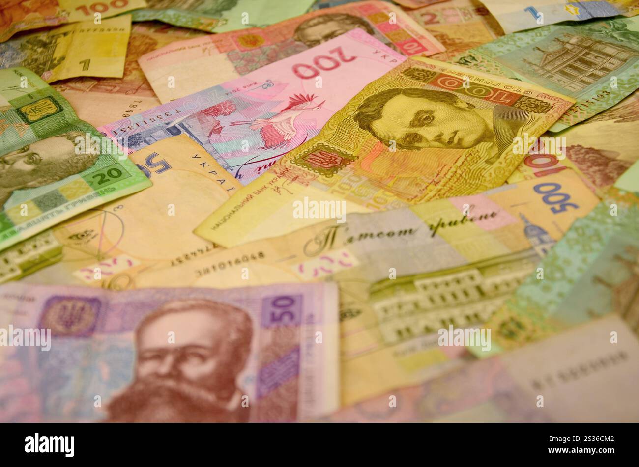 The background image of a pile of Ukrainian banknotes of different ...