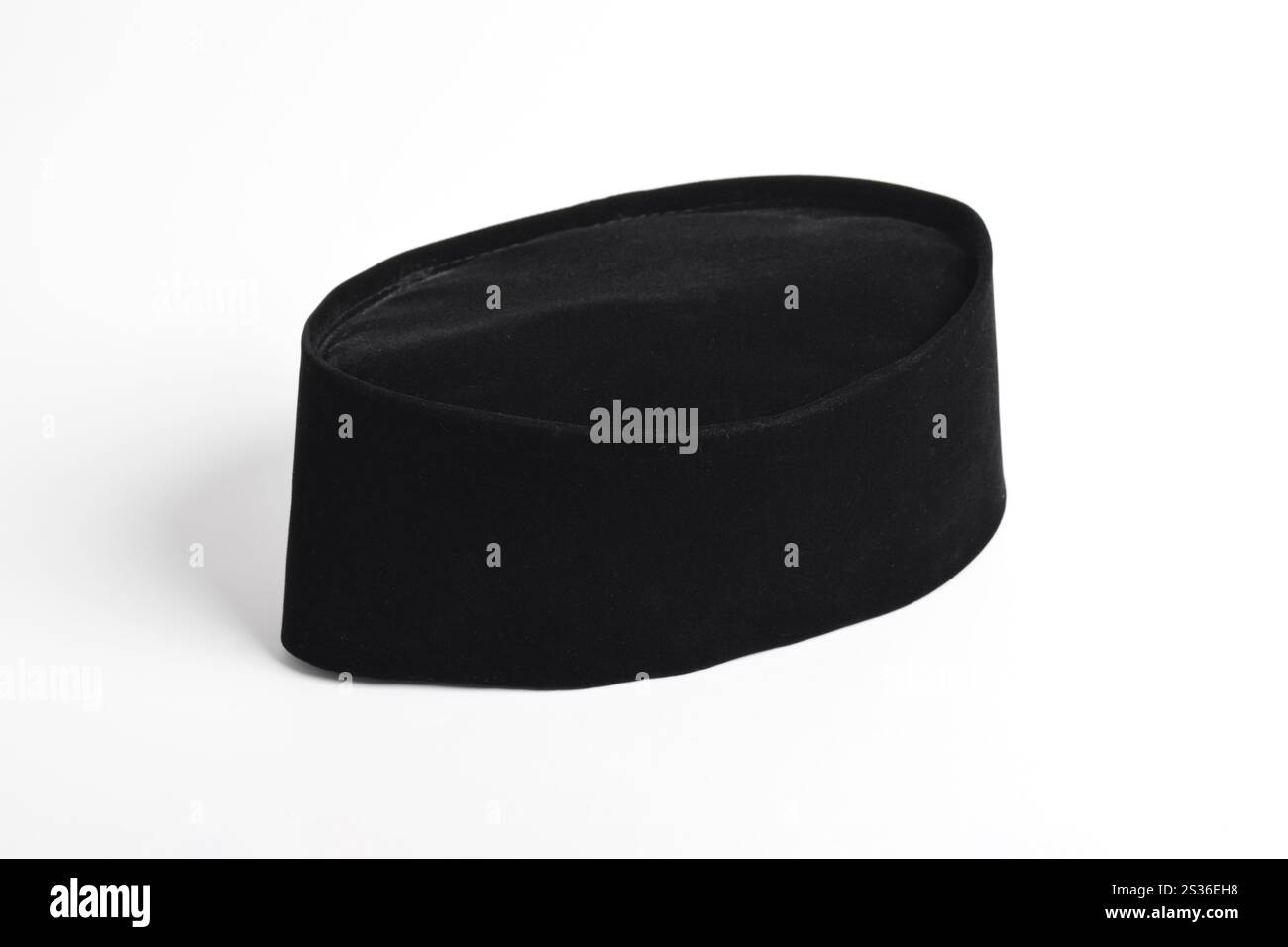 Black Peci or Songkok. Songkok or traditional cap for muslims isolated on white background. a head covering made of velvet, and often worn by Asian Mu Stock Photo