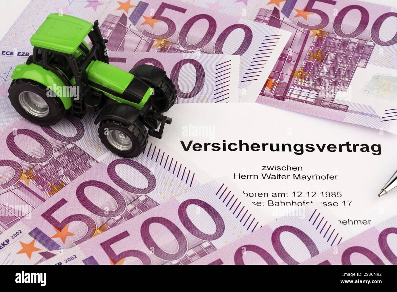 Tractor Insurance An insurance contract for a new tractor. With euro money and biros ...