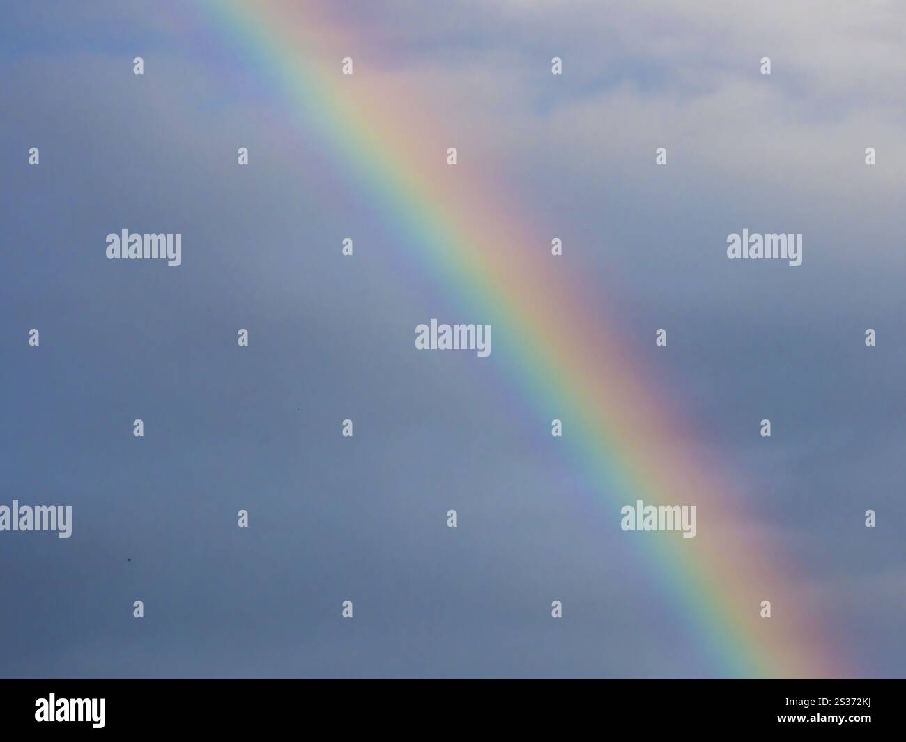 A rainbow appears in the sky after a thunderstorm Stock Photo - Alamy