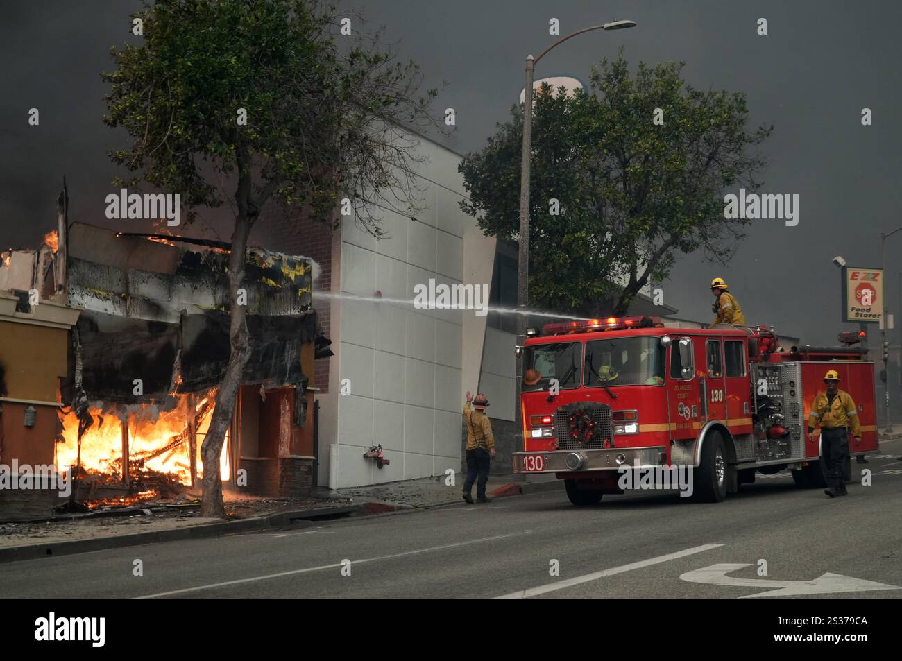 Los Angeles County Fire Dept. firefighters battle flames at the Iglesia ...