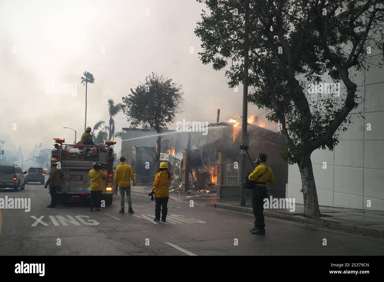 Los Angeles County Fire Dept. firefighters battle flames at the Iglesia ...