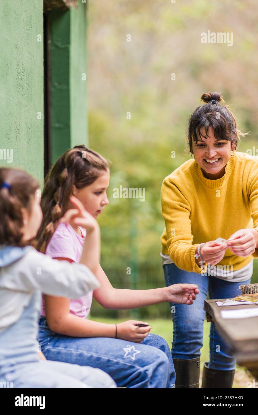 Environmental educator engaging with two girls, sharing knowledge and ...