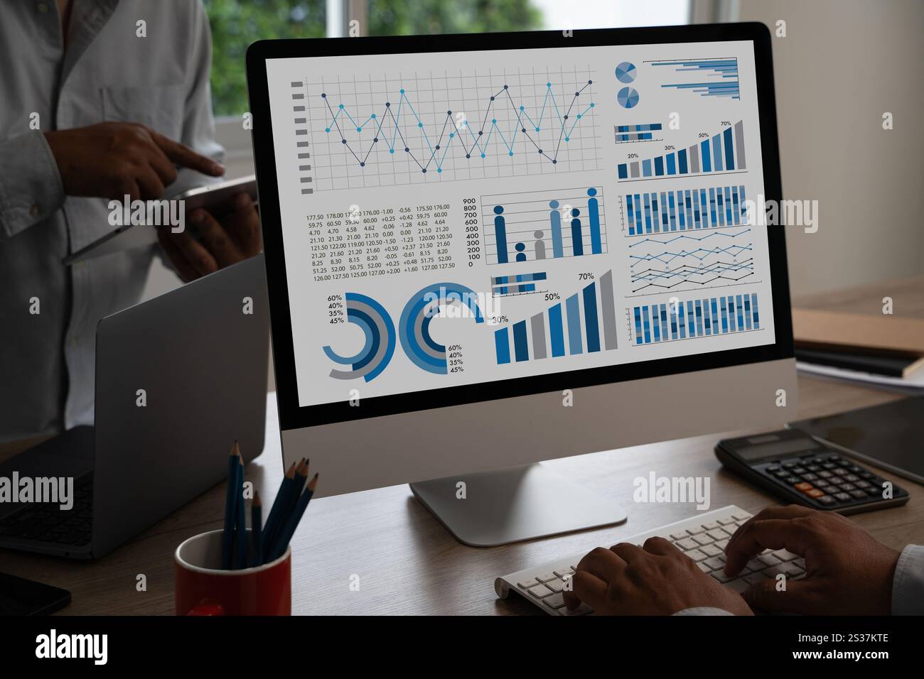 businessman works Statistics Data Dashboard Information Business Technology and Strategy Research analyzing data on computer Stock Photo