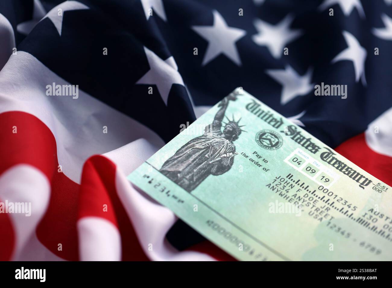 United states treasury refund check on waving american flag close up