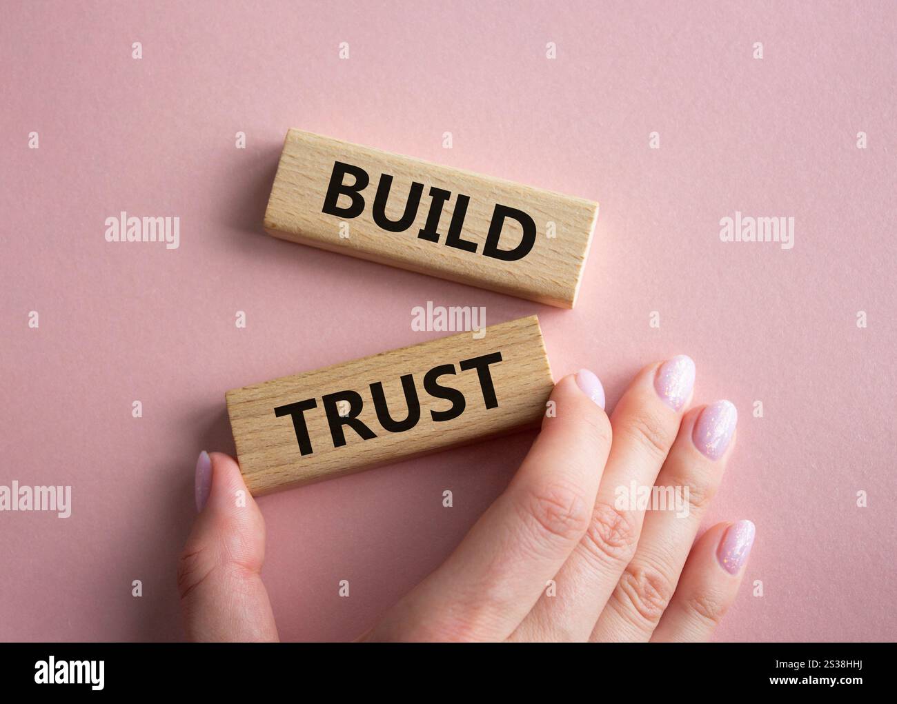 Build trust symbol. Wooden blocks with words Build trust. Beautiful ...