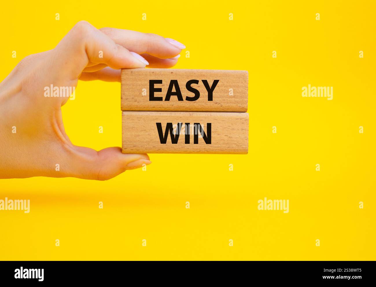 Easy win symbol. Wooden blocks with words Easy win. Beautiful grey ...