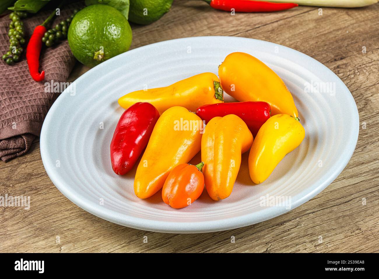 Small baby red and yellow bell pepper heap Stock Photo - Alamy