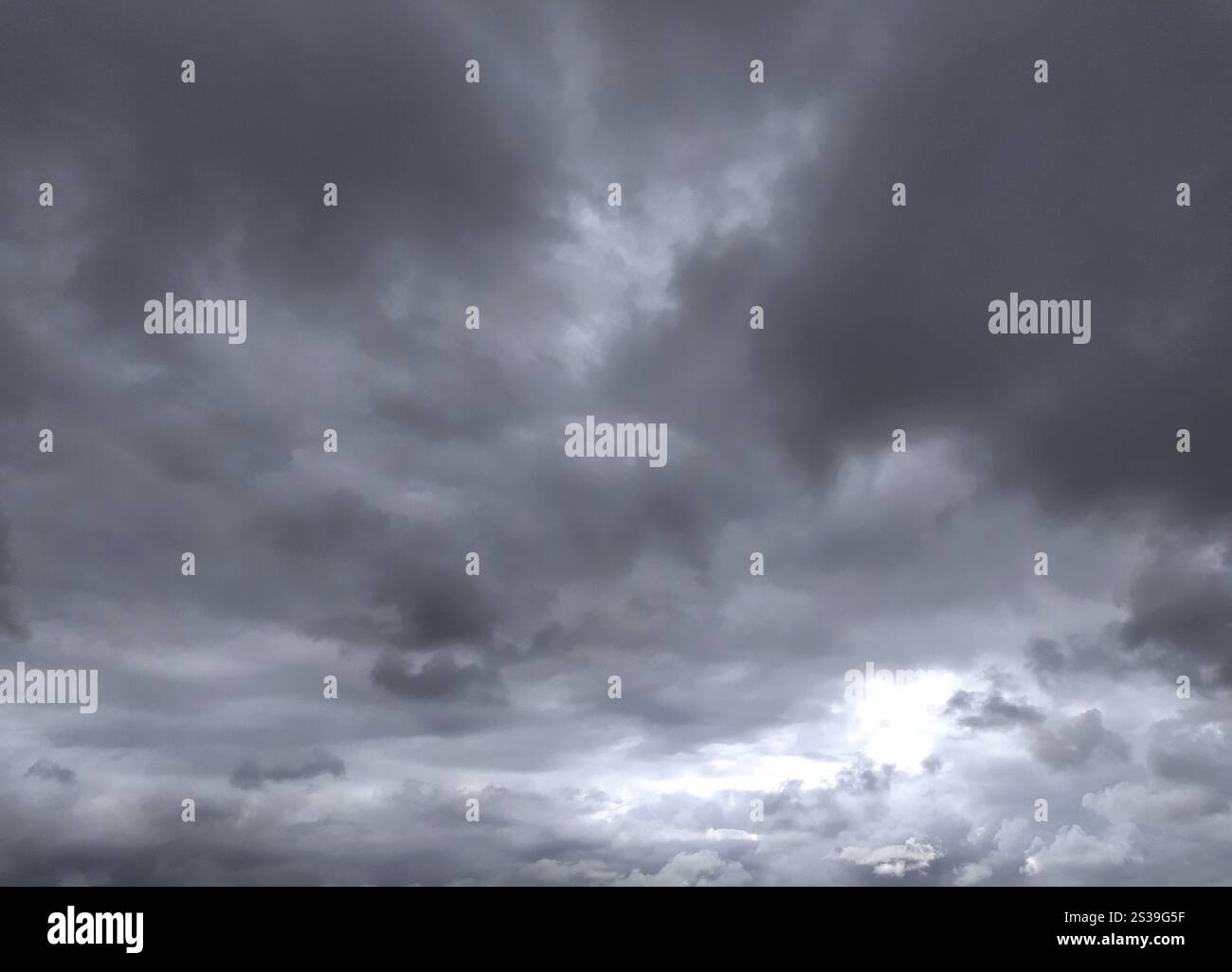 Grey dramatic sky with storm clouds dark landscape. Atmosphere and meteorology. Grey dramatic sky with storm clouds dark landscape. Stock Photo