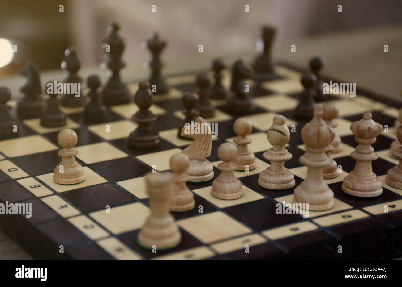 The chess board with the pieces in the dark vintage room interior. The ...