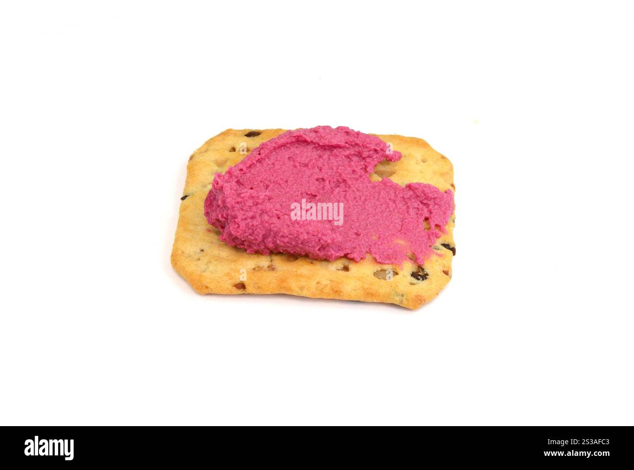 Beetroot hummus spread on a cracker isolated on white background Stock Photo