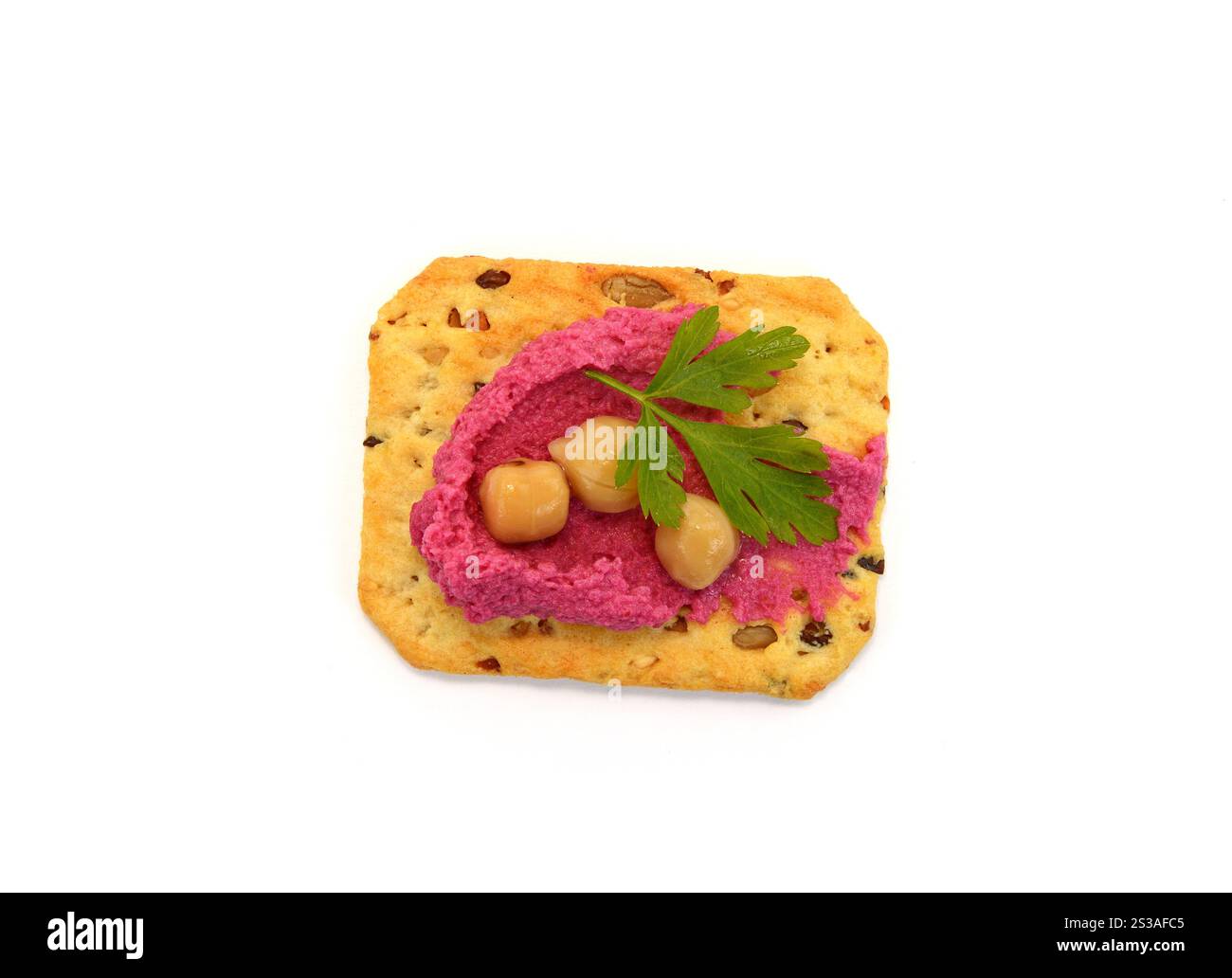 Beetroot hummus spread on a cracker isolated on white background Stock Photo