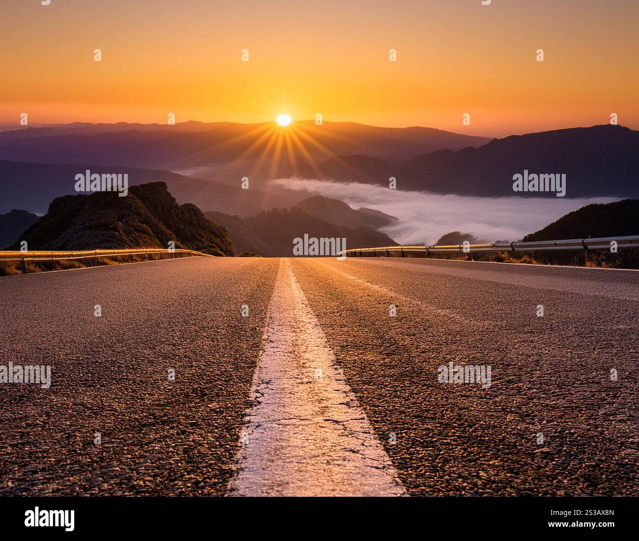 A winding road stretches through a mountainous region, bathed in the ...