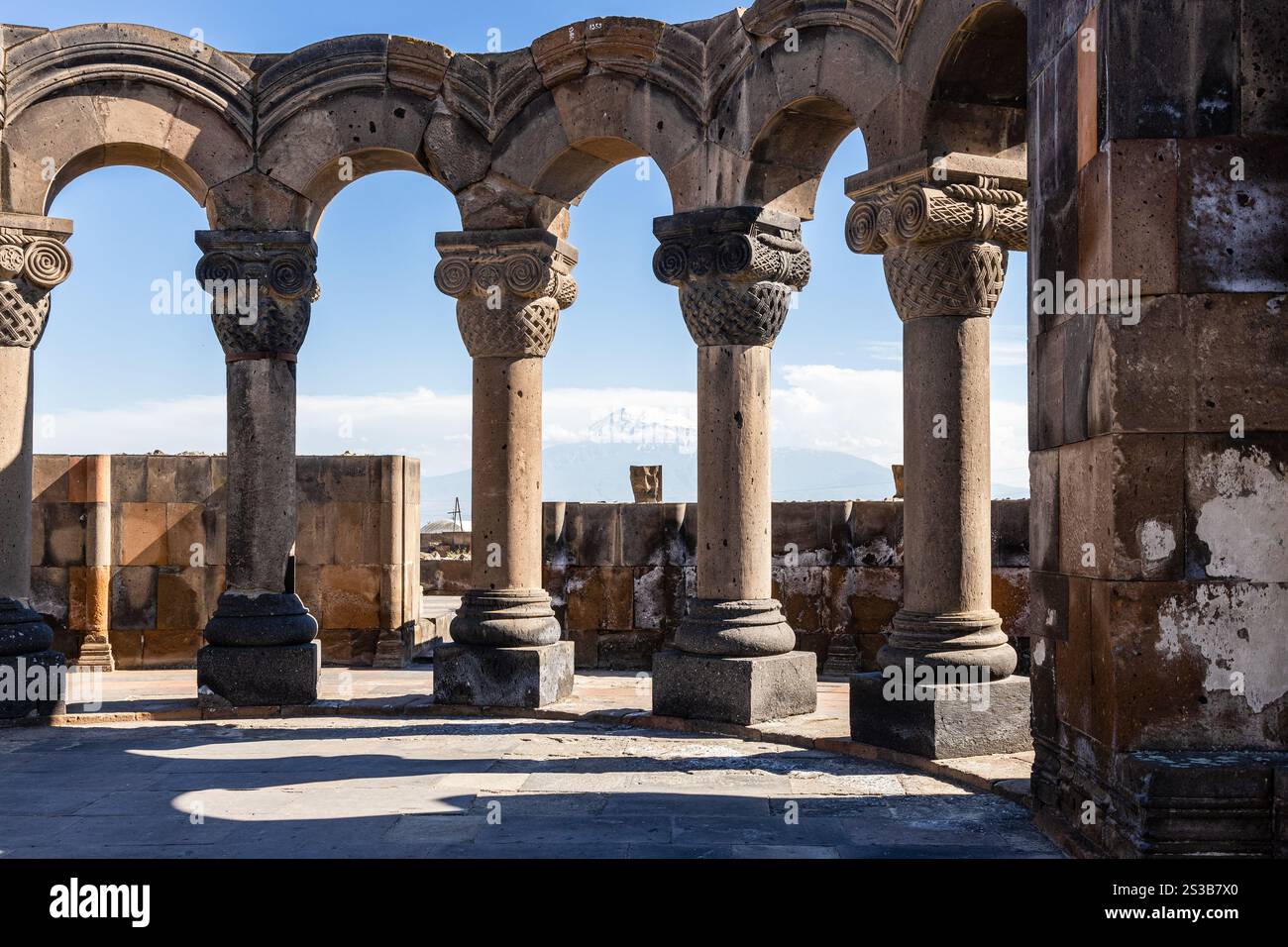 colonnade in Zvartnots Cathedral in Armenia on sunny summer day. Zvartnots ruins are listed in UNESCO World Heritage Sites Stock Photo