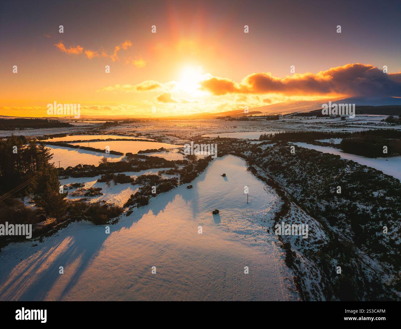 Sunset over snowy fields in the Wicklow Mountains Stock Photo