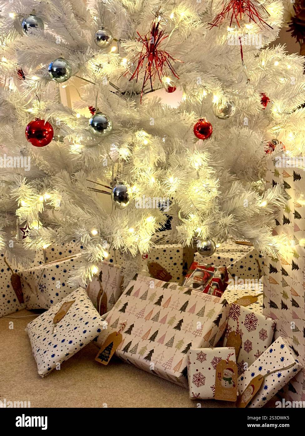 Artificial Christmas tree with presents beneath. - Smartphone Captured Stock Image