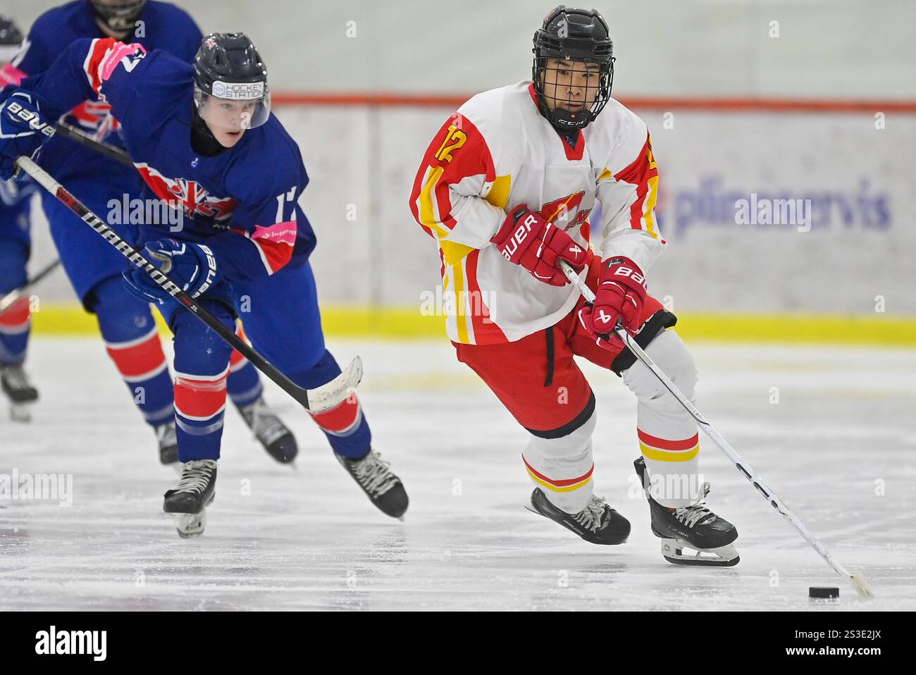 Zijian Zhou of China plays the puck during the 2025 Ice Hockey U20