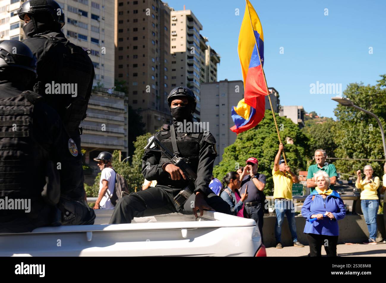 Security forces patrol past opponents of Venezuelan President Nicolas
