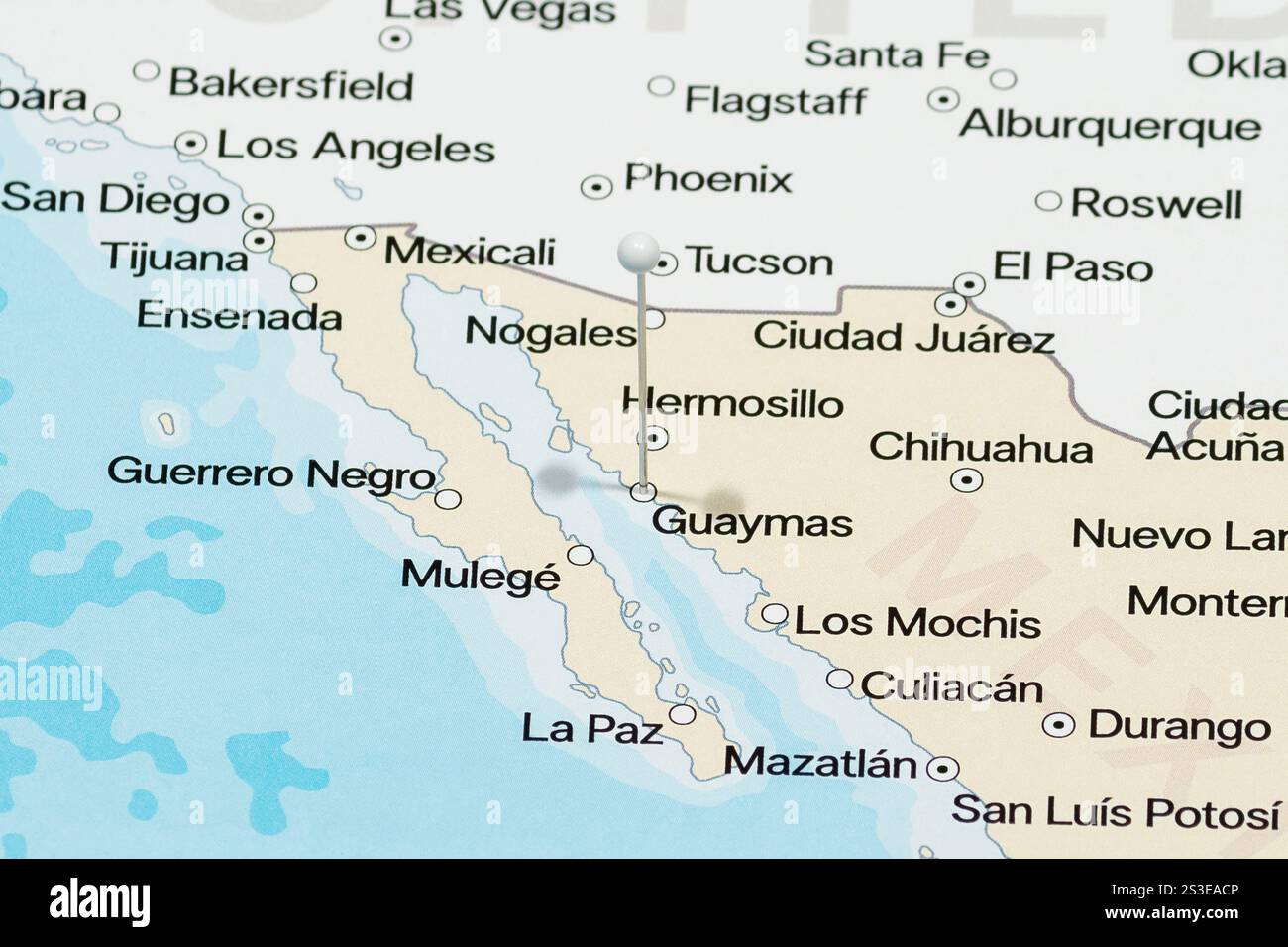 Macro photo of a white pin needle into Guaymas of Mexico political map Stock Photo