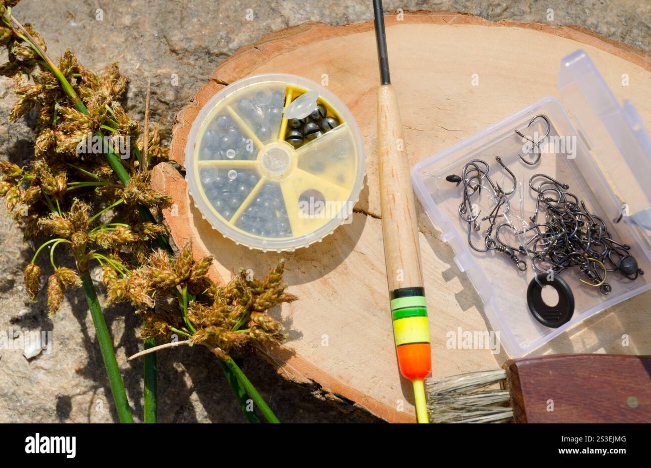 Spring Tackle Spring fishing. Fishing tackle on a stone near the Dnieper River. Hooks ...