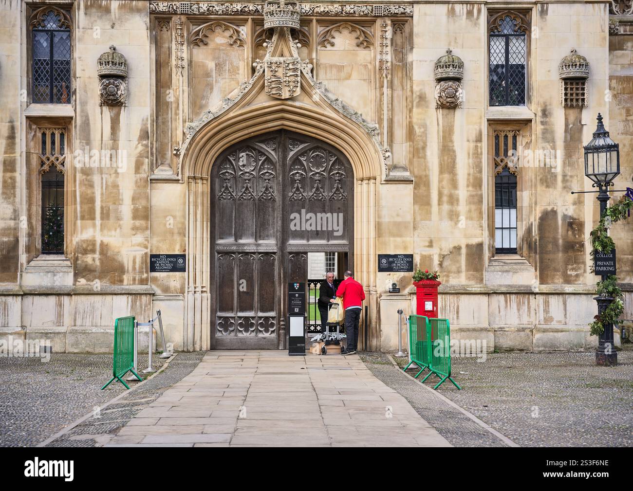 Postman at the main entrance door to King's College, University of