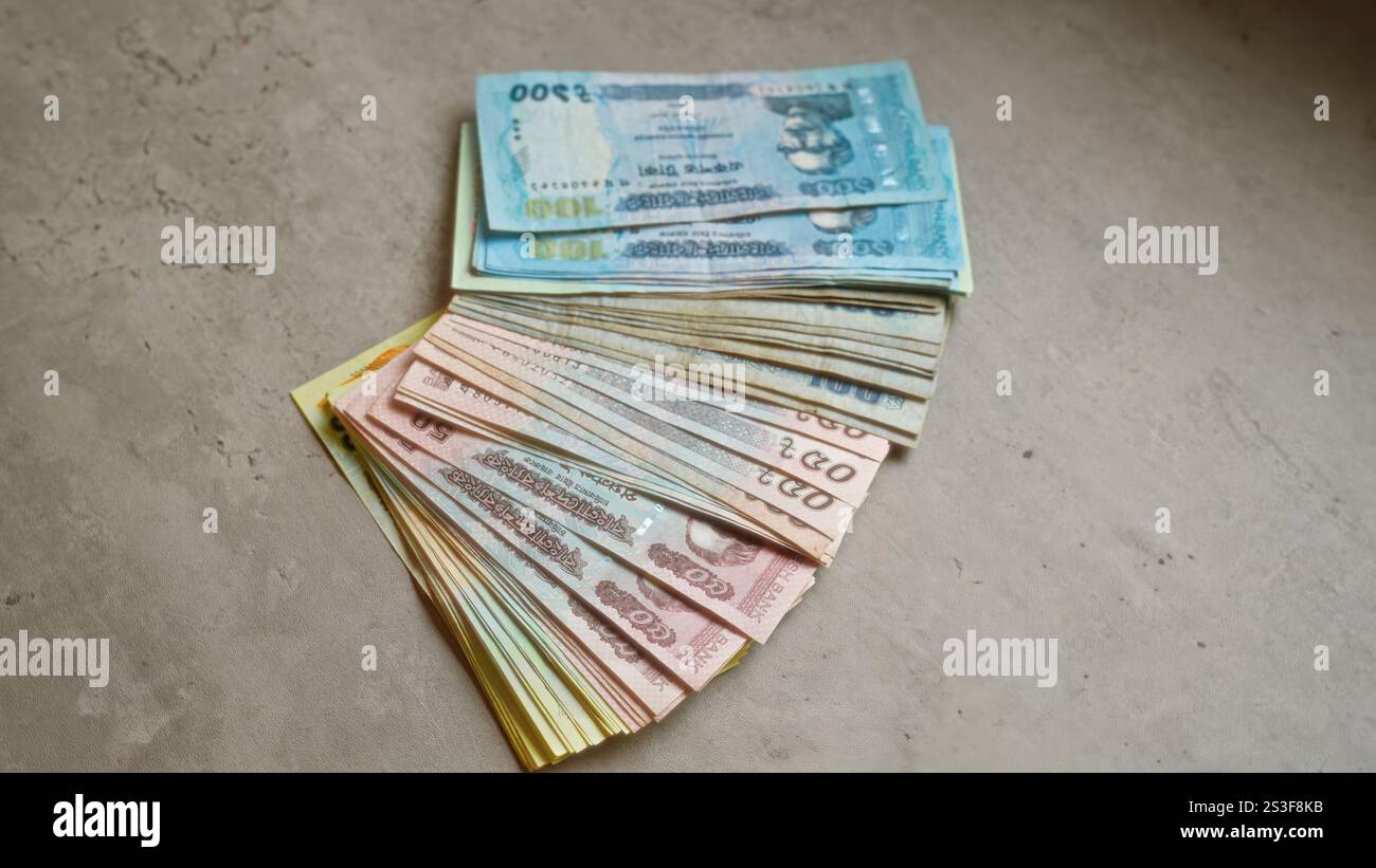 Bangladesh taka banknotes arranged on a concrete surface, showcasing local currency in various denominations. Stock Photo