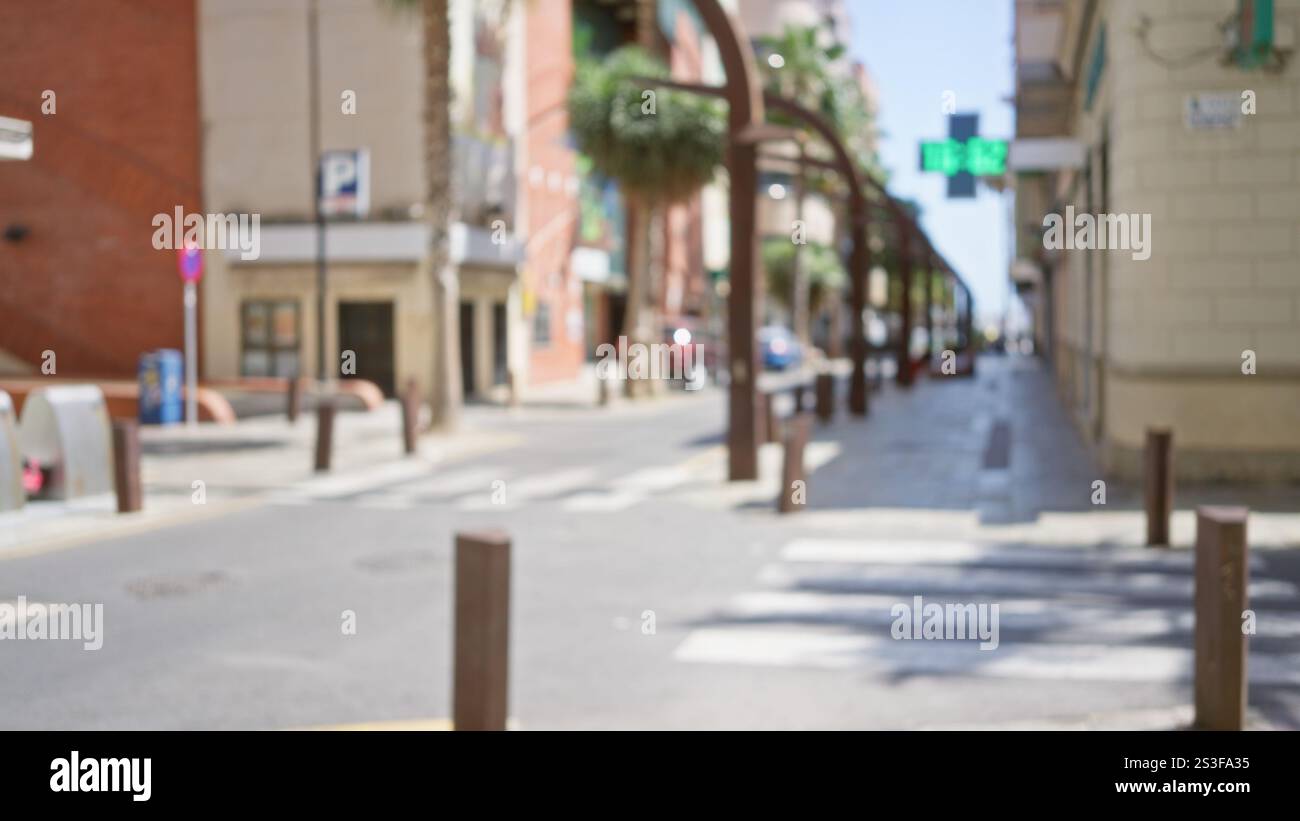 Blurred urban street scene with defocused buildings, palm trees, and ...