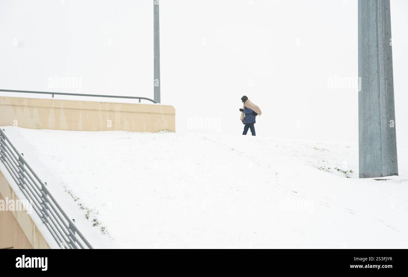 Frank walks on a snow covered overpass Thursday, Jan. 9, 2025