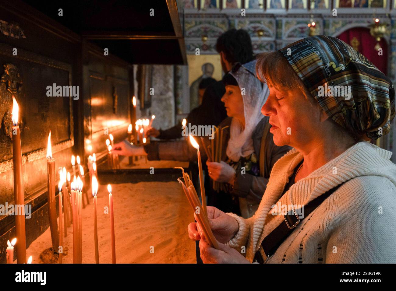 January 7, 2025, Lod, Israel A woman seen lighting candles in the